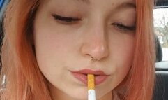 Sweet redhead smoking in car