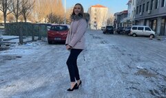 girl decided to walk to the store in high-heeled shoes, but the whole road was covered in ice, her heels were slipping a lot