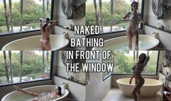 Naked bathing in front of a big window