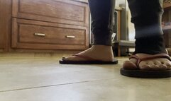 Close up dirty feet in flip-flops and ankle brace