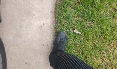 Fifi driving impatiently in Doc Martens boots and pinstripe pants