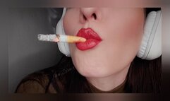 Close-up smoking with big headphones on