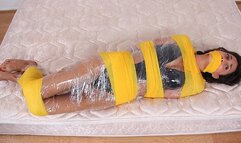 Swimsuit Clad Babe Gia Mancini Is Coiled In Plastic And Bright Yellow Bandages!