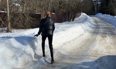 girl walks through the snowdrifts in high-heeled boots and falls deep into the snow