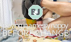 Playing in a messy nappy before change