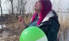 Smoking loner on nature blowing balloon with cigarette