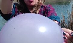 smoking girl blow and poping balloons in latex glove on nature