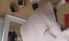 Vacuuming floir and leggings in a cozy jacket and nylon socks