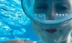 Underwater breathhold and bubble blowing fun in the swimming pool