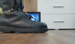 Firefighter crushing old Laptop