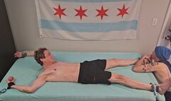 Colin Bryant playfully tickled on the bed