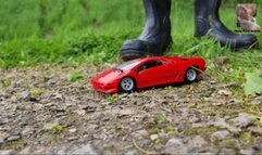 Red metal Car under black Wellies