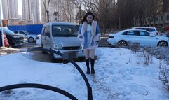 Chinese girl tickles outdoors in winter when it's too cold