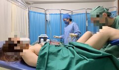 Two Asian doctors anal and vaginal examination of a female patient