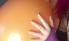 sexy in latex body with nacked tits blowing balloon