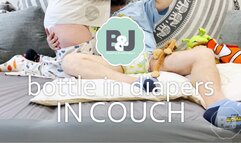 Bottle in diapers in couch