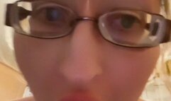 Girl in huge eyeglasses is yawning in the kitchen