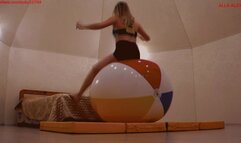 Alla does gymnastics with a large beach ball and has fun jumping on it and pumping it up with her mouth