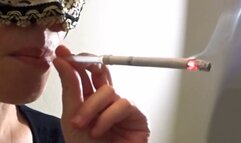 Smoking Muratti red 100s with glass holder